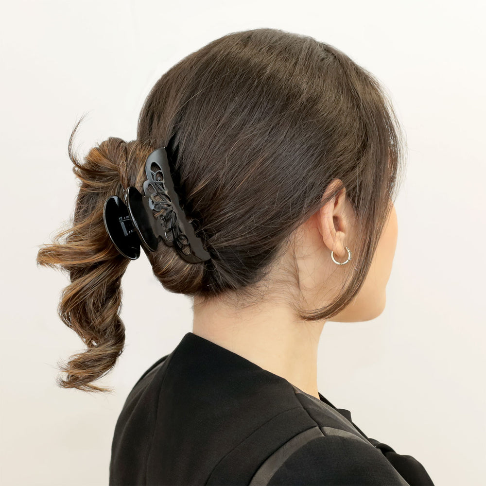 Hochsteckfrisur mit großer, schwarzer Haarklammer London mit Arabeske