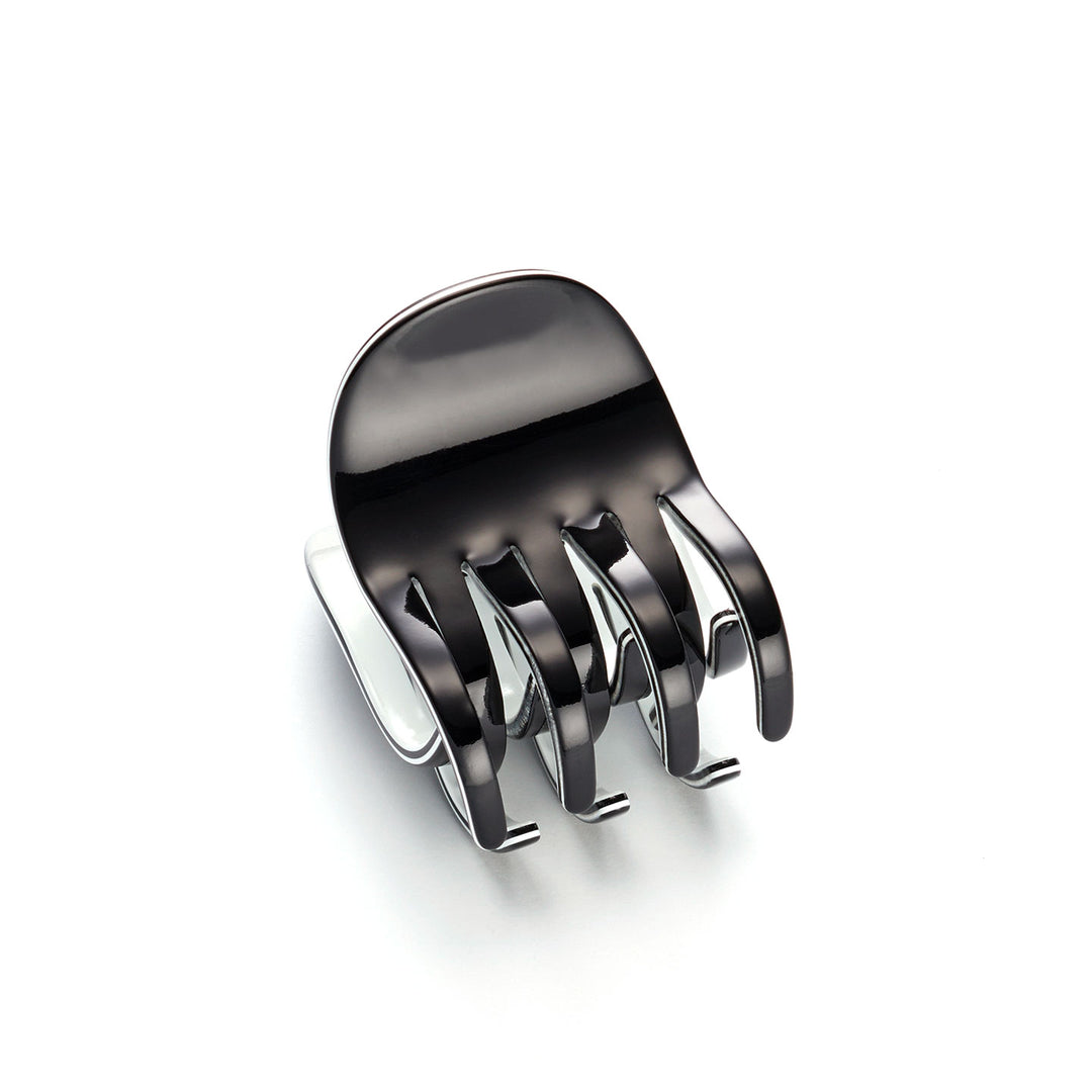 Mittelgroße Haarklammer in Schwarz mit weißem Rand aus Rhodoïd – vier Zahnreihen, elegantes London-Design.